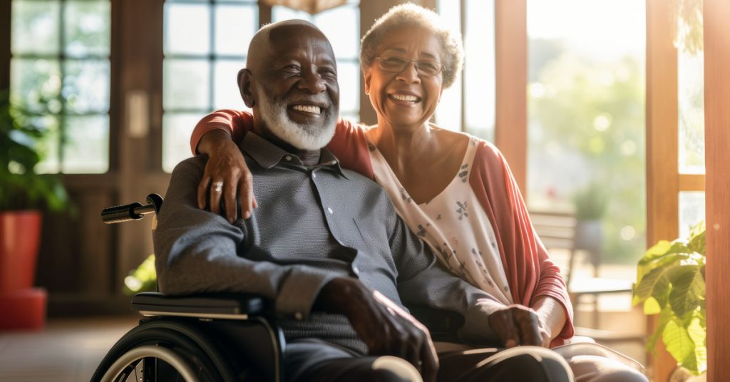 Older couple smiling in front of widow
